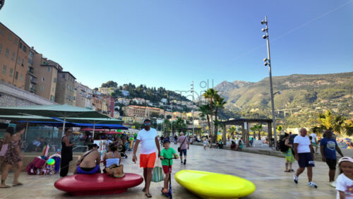Video - Menton, France - September 4, 2024: People walking on the coastline in the evening