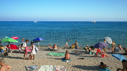 Video - Menton, France - September 4, 2024: People swimming and relaxing on the beach