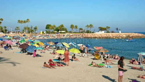 Video - Menton, France - September 4, 2024: People swimming and relaxing on the beach