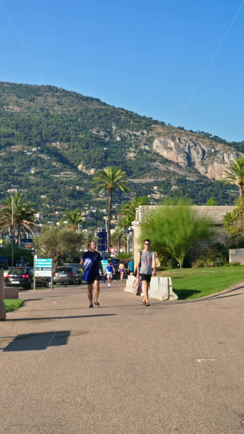 Video - Menton, France - September 4, 2024: People walking on the streets of the city. Vertical