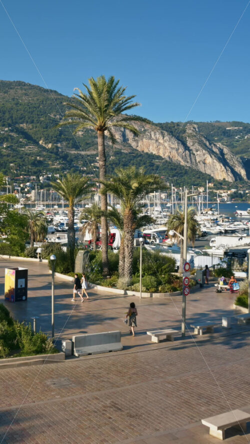 Video - Menton, France - September 4, 2024: Cars moving on the streets of the city near the harbour. Vertical