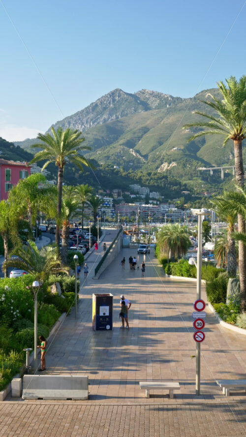 Video - Menton, France - September 4, 2024: People and cars moving on the streets of the city. Vertical
