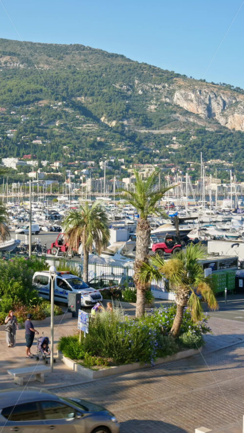 Video - Menton, France - September 4, 2024: People and cars moving on the streets of the city. Vertical