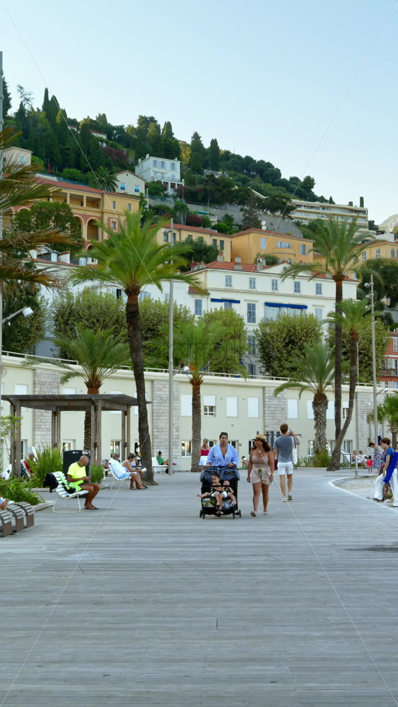Video - Menton, France - September 4, 2024: People walking on the coastline in the evening. Vertical