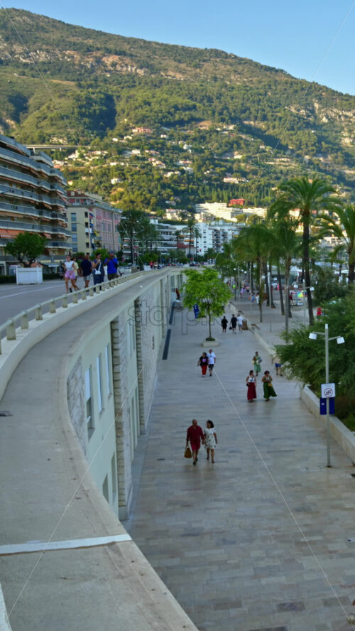 Video - Menton, France - September 4, 2024: People walking on the coastline. Vertical