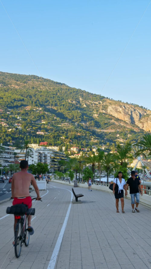 Video - Menton, France - September 4, 2024: People walking on the streets of the city. Vertical