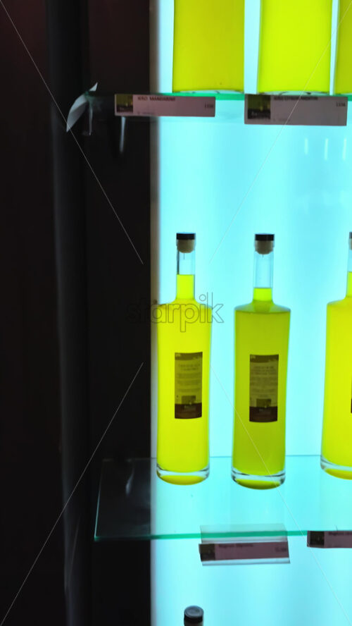 Video - Close up of bottles of limoncello in a store in Menton, France. Vertical