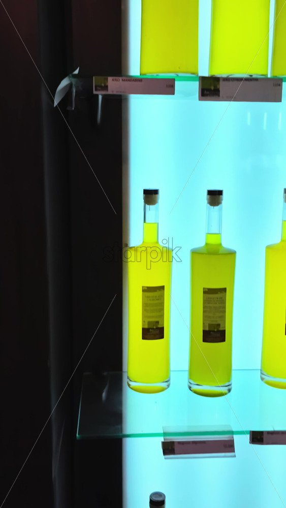 Video - Close up of bottles of limoncello in a store in Menton, France. Vertical