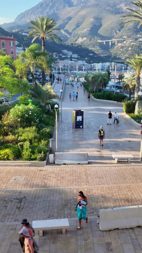 Video - Menton, France - September 4, 2024: People and cars moving on the streets of the city. Vertical