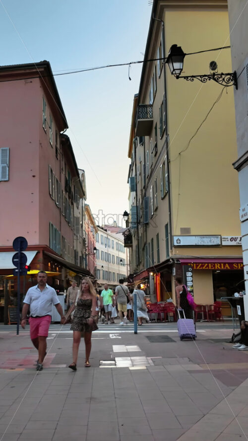 Video - Menton, France - September 4, 2024: People walking on the streets of the city. Vertical