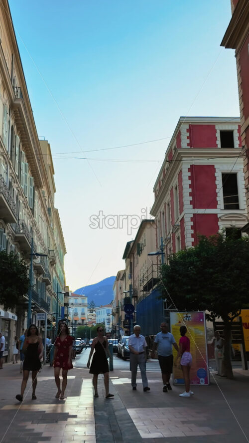 Video - Menton, France - September 4, 2024: People walking on the streets of the city. Vertical