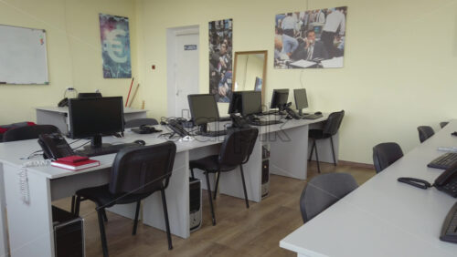 Video - Multiple personal computers on desks at an office