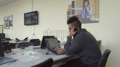 Video - Man speaking on the telephone in an office