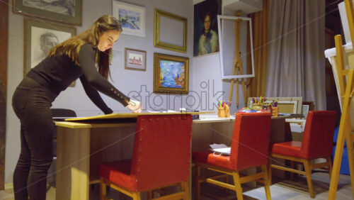 Video - Woman sketching on a canvas at an art gallery workshop