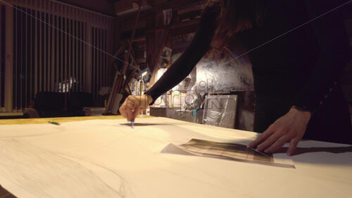 Video - Woman sketching on a canvas at an art gallery workshop
