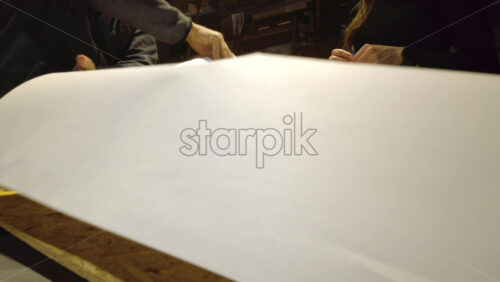 Video - Man supervising a woman sketching on a canvas at an art gallery workshop