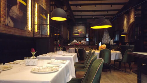 Video - Empty tables with green chairs at a restaurant