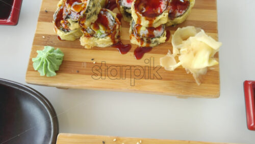 Video - Close up of sushi rolls on wooden trays at a restaurant
