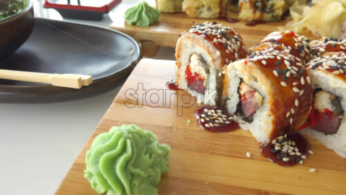 Video - Close up of sushi rolls on wooden trays at a restaurant
