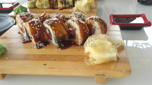 Video - Close up of sushi rolls on wooden trays at a restaurant