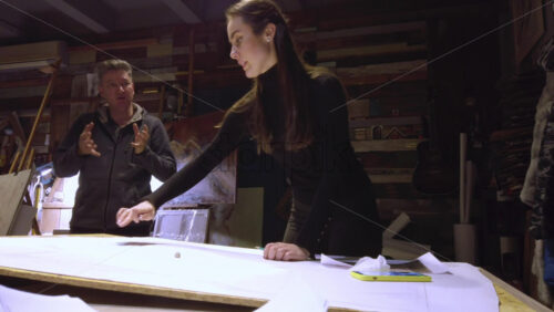 Video - Man supervising a woman sketching on a canvas at an art gallery workshop