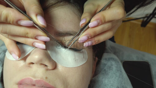 Video - Close up of a woman doing lash extensions to another woman