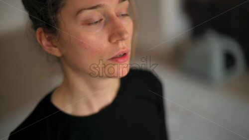 Video - Close up of a woman in sportswear stretching at home