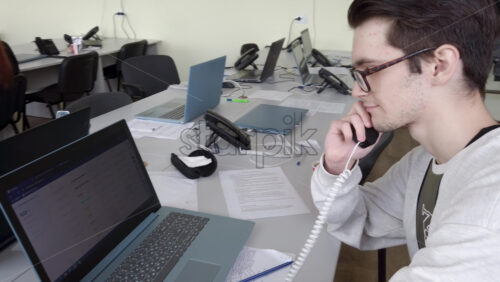 Video - Chisinau, Moldova - April 20, 2021: Man speaking on the telephone in an office