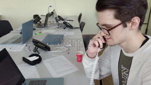 Video - Man speaking on the telephone in an office