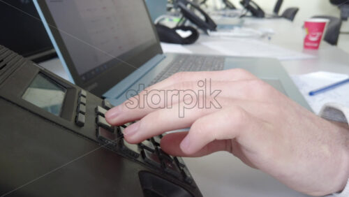 Video - Chisinau, Moldova - April 20, 2021: Man speaking on the telephone in an office