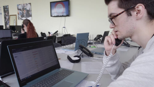 Video - Chisinau, Moldova - April 20, 2021: Man speaking on the telephone in an office