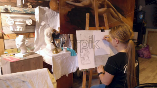 Video - Girl sketching on a paper at an art gallery workshop