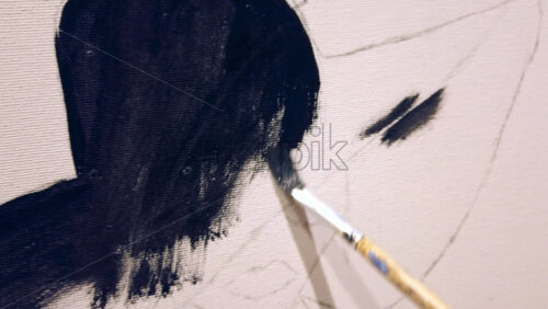 Video - Close up of a woman paining on a paper at an art gallery workshop