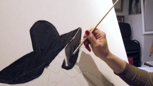 Video - Close up of a woman paining on a paper at an art gallery workshop