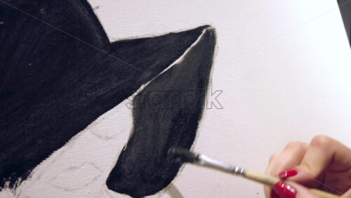 Video - Close up of a woman paining on a paper at an art gallery workshop