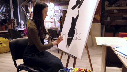 Video - Woman paining on a paper at an art gallery workshop