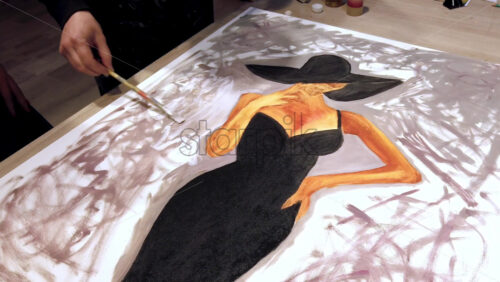 Video - Woman paining on a paper at an art gallery workshop
