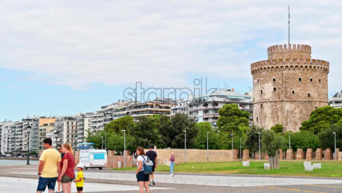 Video - THESSALONIKI, GREECE - SEPTEMBER 21, 2020: Tourists visiting the White Tower and the city. The trees seem to be a part of the monument