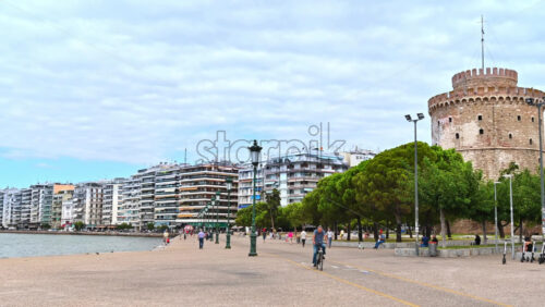 Video - THESSALONIKI, GREECE - SEPTEMBER 21, 2020: A wide panoramic view of the street placed on the coast of Thessaloniki. Tourists and locals walking