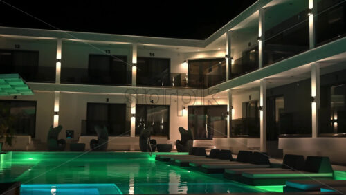 Video - THESSALONIKI, GREECE - SEPTEMBER 21, 2020: A relaxing place of a hotel. A swimming pool, some lights, chairs, tables - everything for clients' comfort