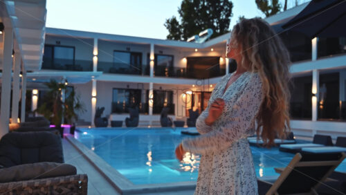 Video - Woman relaxing near the hotel pool