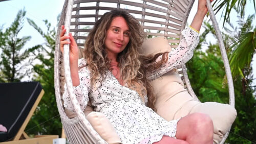 Video - Woman creating happy moments while being on vacation and swinging