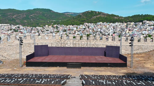 Video - Theatre located in the old Fortress in Kavala, Greece, Rows of seats, scene. Buildings and hills on the background