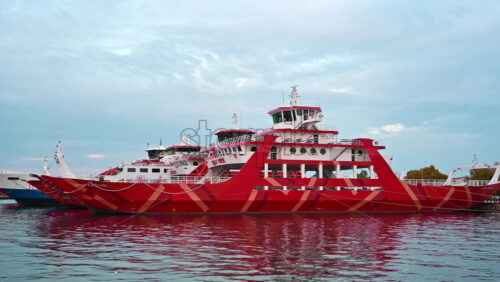 Video - THASSOS, GREECE - SEPTEMBER 23, 2020: Moored ferryboat in the port with red exterior, closed gangplank