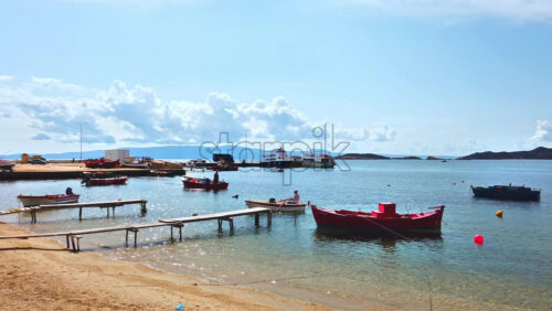 Video - Sea port, multiple moored and moving boats on Aegean sea, hills on the background in Ouranoupolis, Greece
