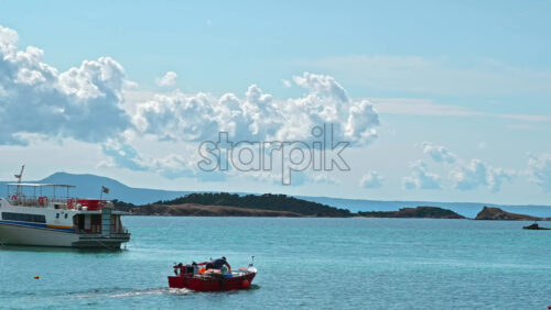 Video - OURANOUPOLIS, GREECE - OCTOBER 2, 2020: Sea port, multiple moored and moving boats on Aegean sea, hills on the background