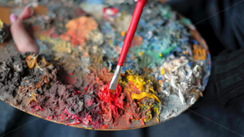 Video - Close up of woman painter mixing watercolor for painting