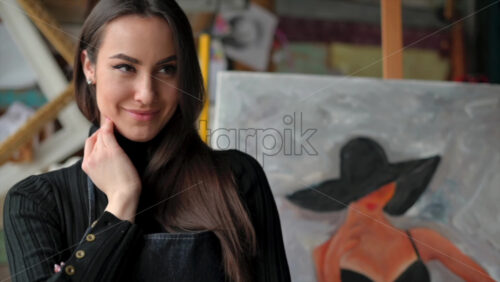 Video - Woman standing in front of a painting at an art gallery workshop