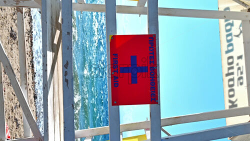 Video - NIKITI, GREECE - OCTOBER 8, 2020: First aid tower with boat and life ring near it, Aegean sea on the background. Vertical shooting. Slow motion