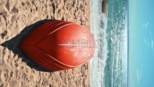 Video - Flipped boat with orange bottom on a beach of Aegean sea in Nikiti, Greece